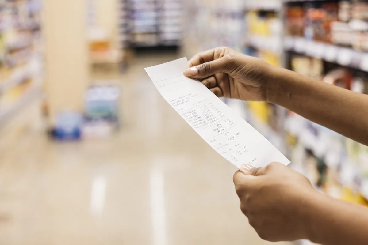 Shopper checking a receipt to confirm a Sam's Club return deadline