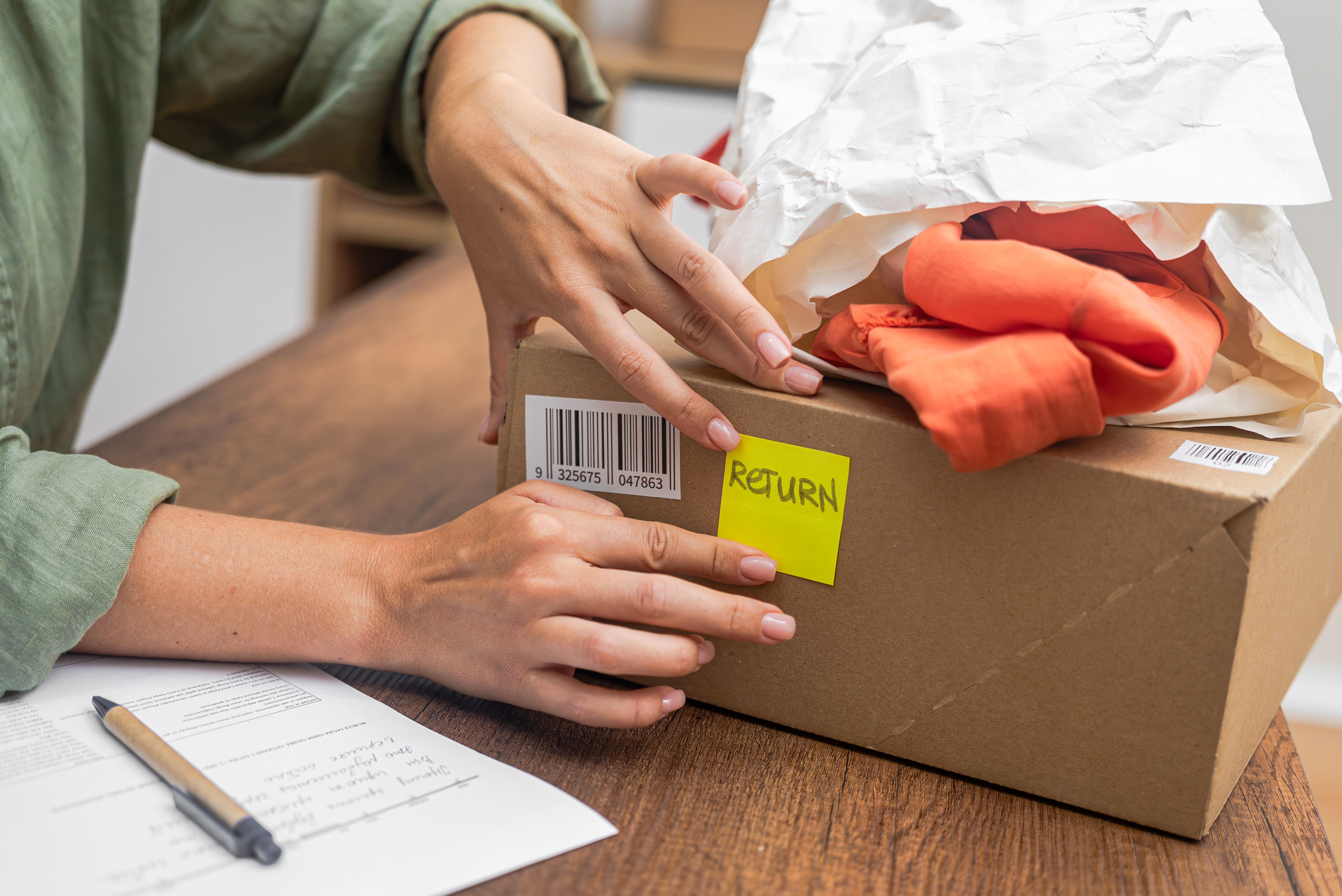 Woman preparing a product return with barcode label on box